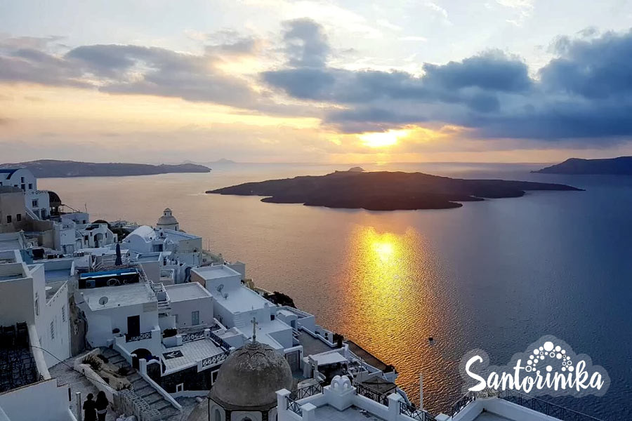 Winter in Santorini: view of the volcano caldera and Nea Kameni Island before sunset